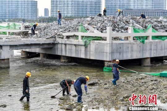 三亚洲际度假酒店海上餐厅项目拆除，工人正在海水中捡拾落入的建筑垃圾，避免二次污染。　骆云飞　摄