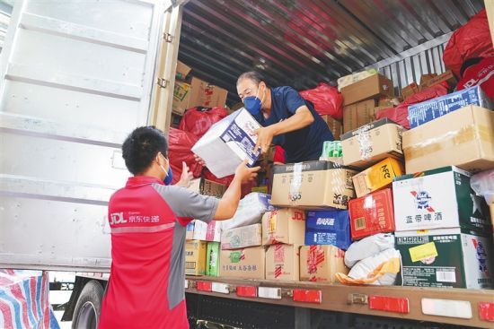 9月9日，在京东快递三亚红沙营业部，快递小哥正忙着搬运配送货品。 本报记者 武威 摄