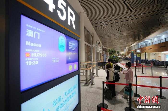 11月29日晚,海口直飞澳门航班旅客排队办理登机手续。 海口美兰国际机场供图