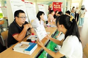 6月28日，招聘会现场，应聘者与企业代表交谈。 本报记者 陈丽园 摄