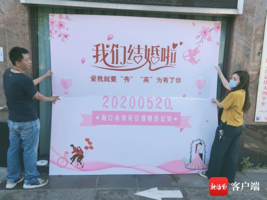 工作人员正在布置拍照背景墙.海口市秀英区民政局供图